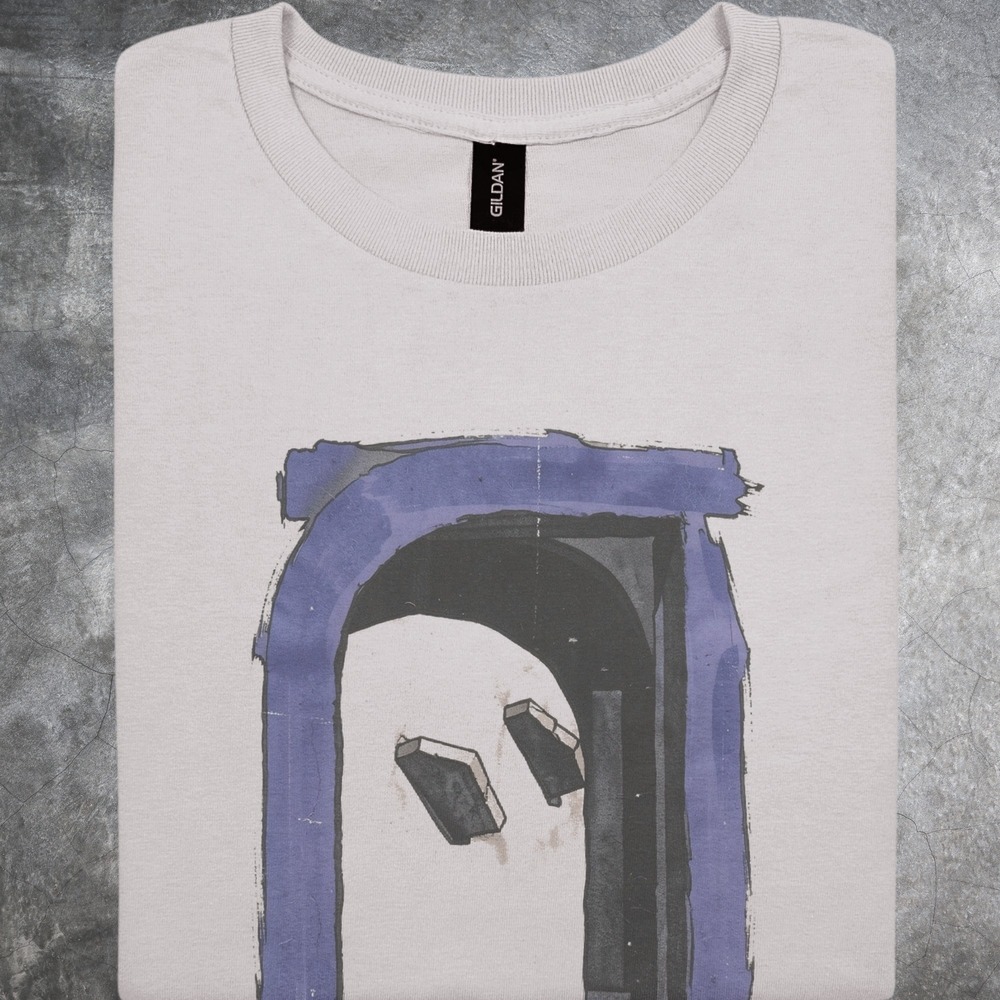Books Tumbling Through a Dark Archway Tee